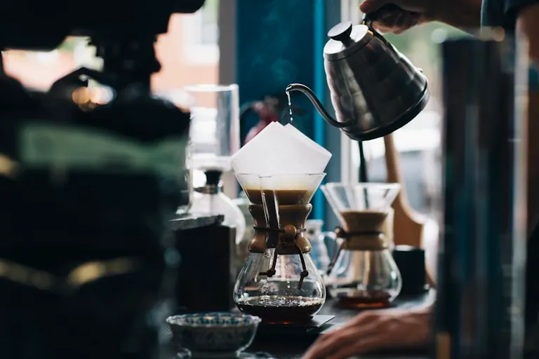 Barista carefully pouring a latte