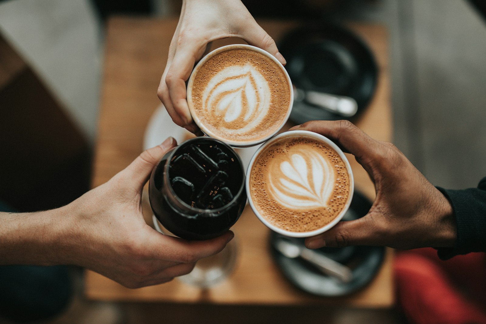 Latte being poured into a ceramic cup