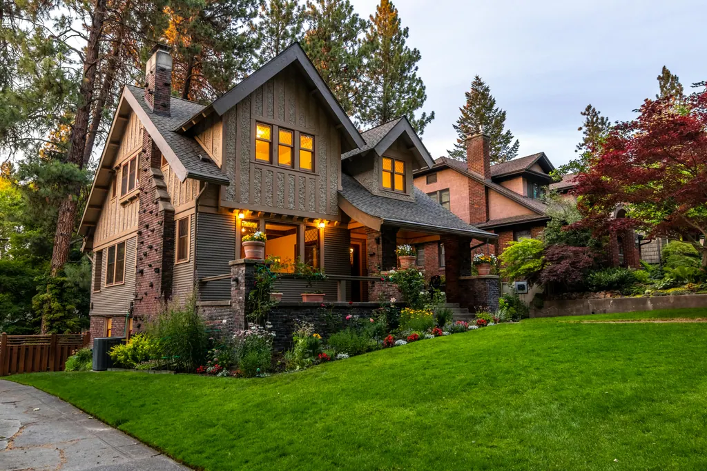 Craftsman home with a freshly cut, healthy green lawn and flower beds