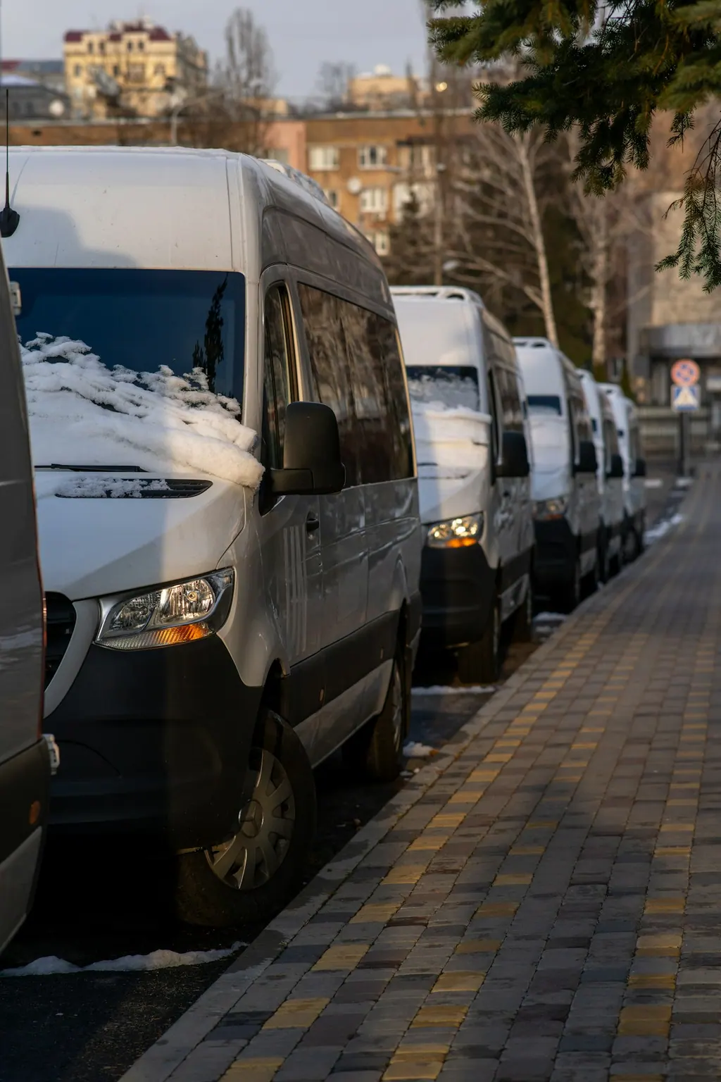 Row of commercial service vans parked outside a garage
