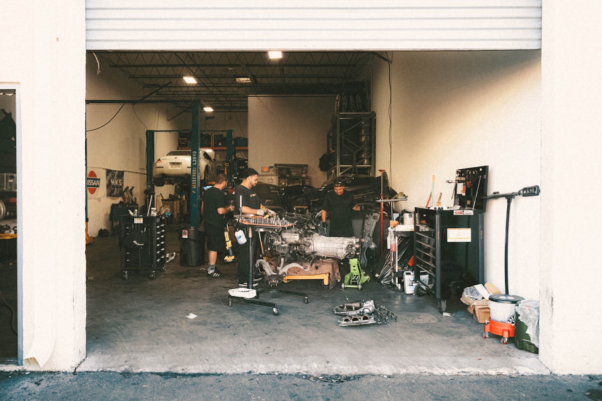 Two technicians at work inside the Plaza Midwood shop