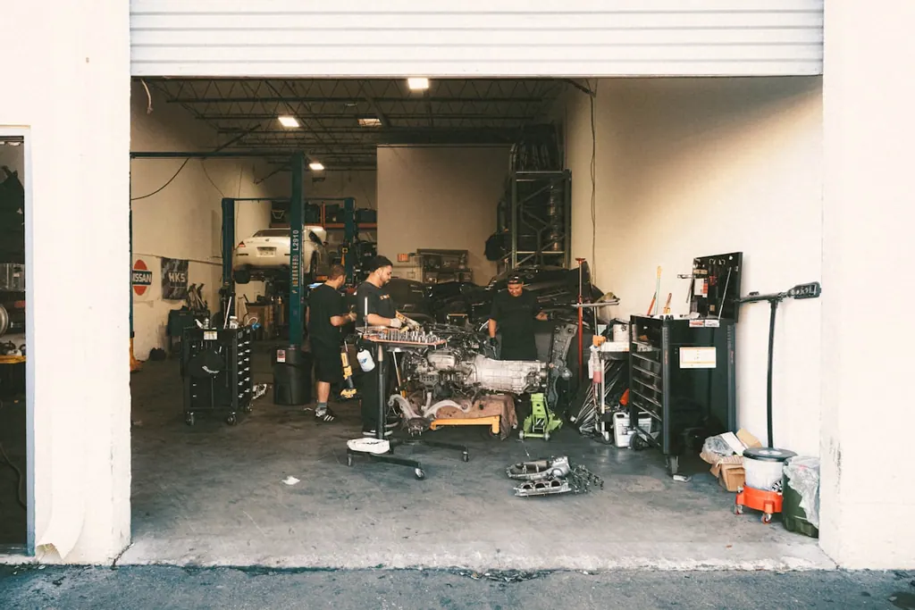 Two technicians at work inside the Plaza Midwood shop